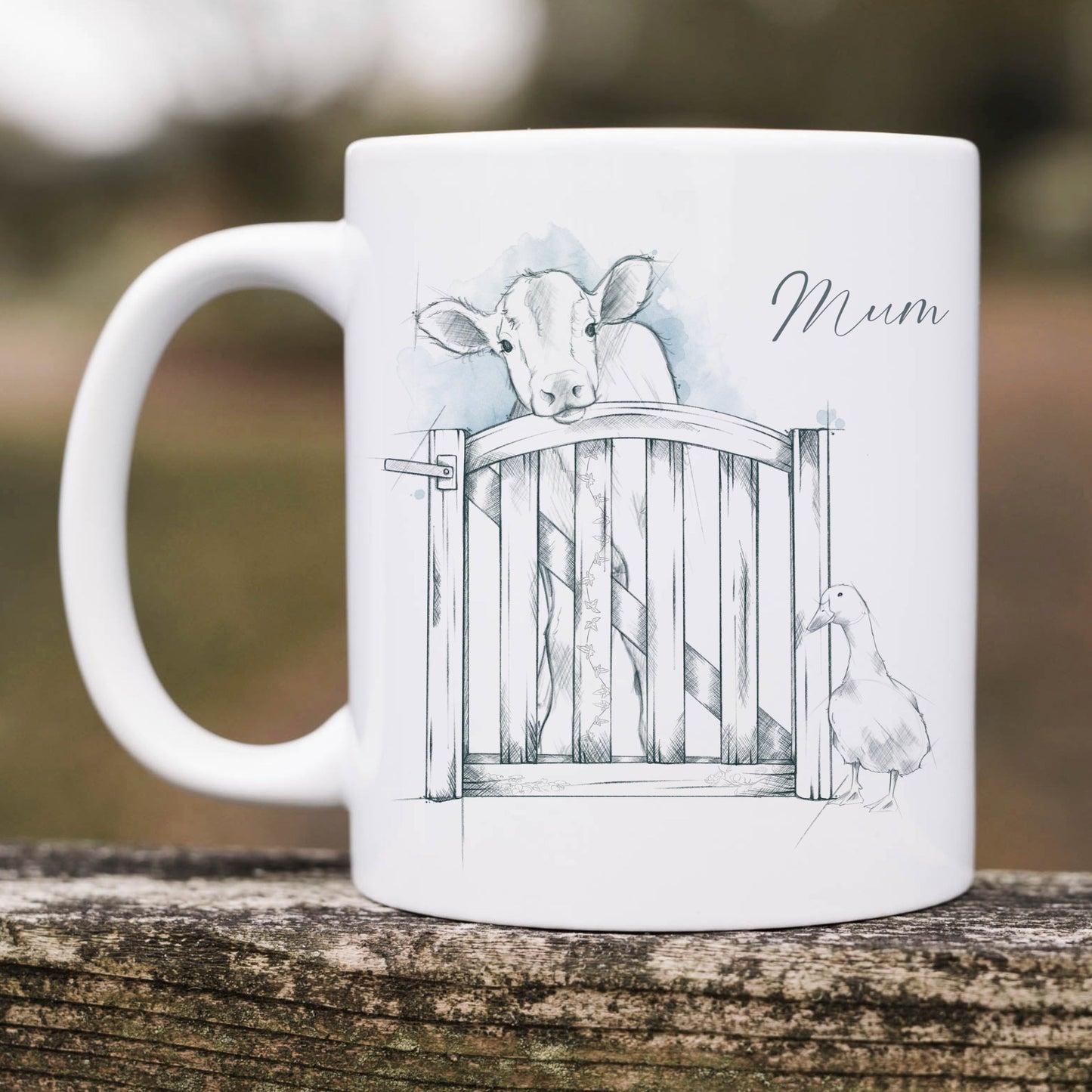 Personalised ceramic mug with a sketched image of a cow and a duck standing at a gate