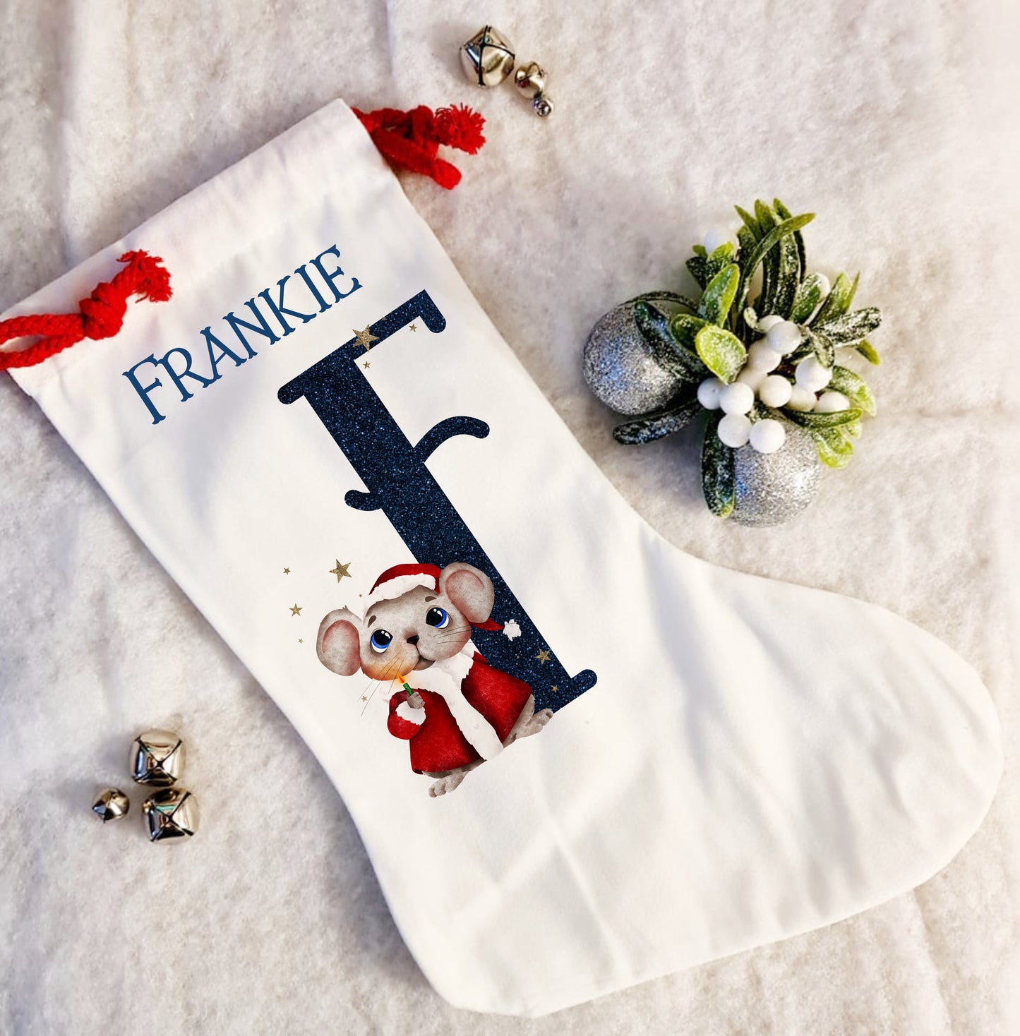 Personalised white Christmas stocking with a red rope tie and a Christmas mouse alphabet in red and navy