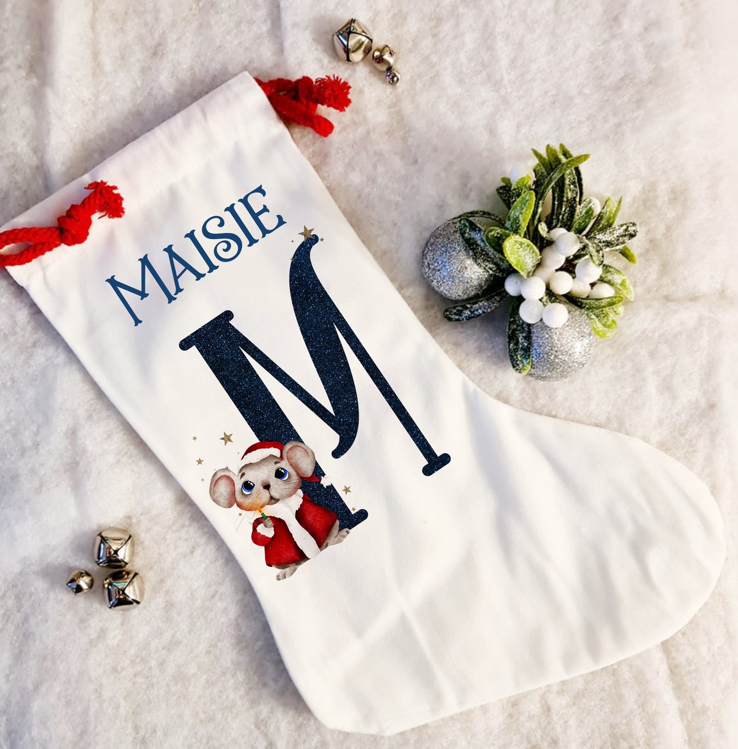 Personalised white Christmas stocking with a red rope tie and a Christmas mouse alphabet in red and navy