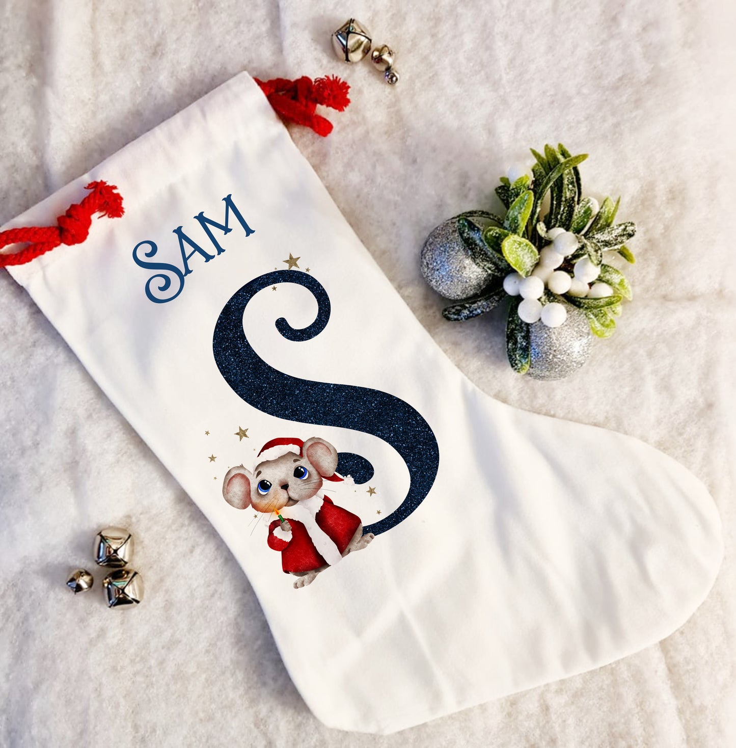 Personalised white Christmas stocking with a red rope tie and a Christmas mouse alphabet in red and navy