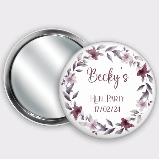 Personalised pocket badge mirror for hen party favours, featuring name and hen party date with a burgundy floral wreath.