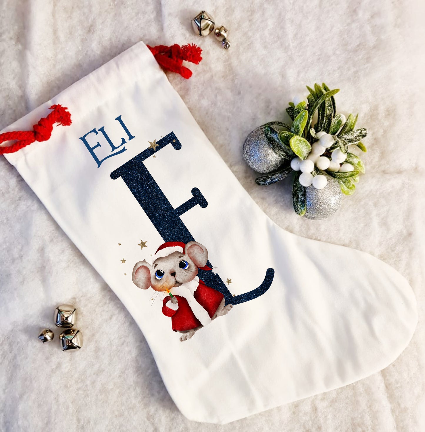 Personalised white Christmas stocking with a red rope tie and a Christmas mouse alphabet in red and navy