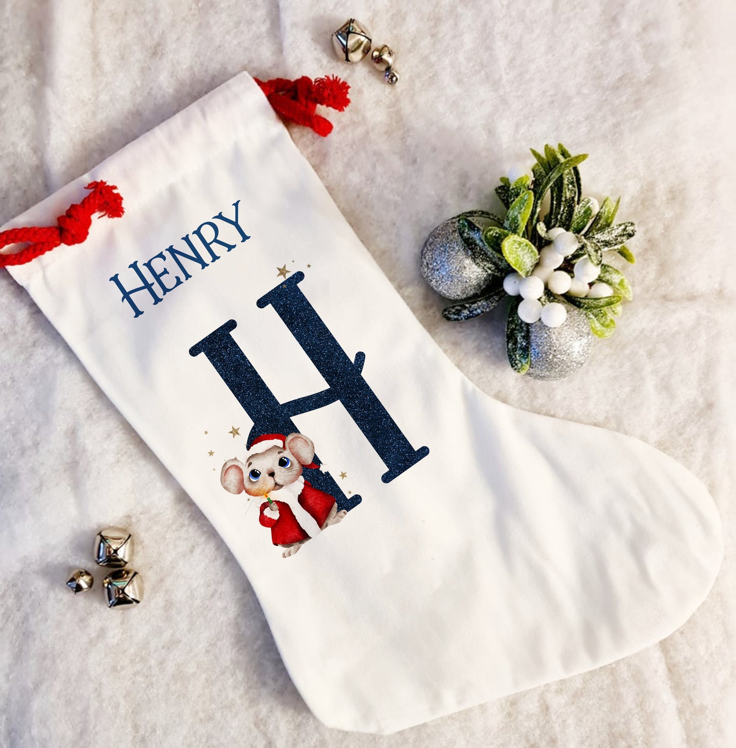 Personalised white Christmas stocking with a red rope tie and a Christmas mouse alphabet in red and navy