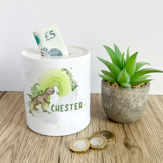 Personalised ceramic money box with a dinosaur and rainbow