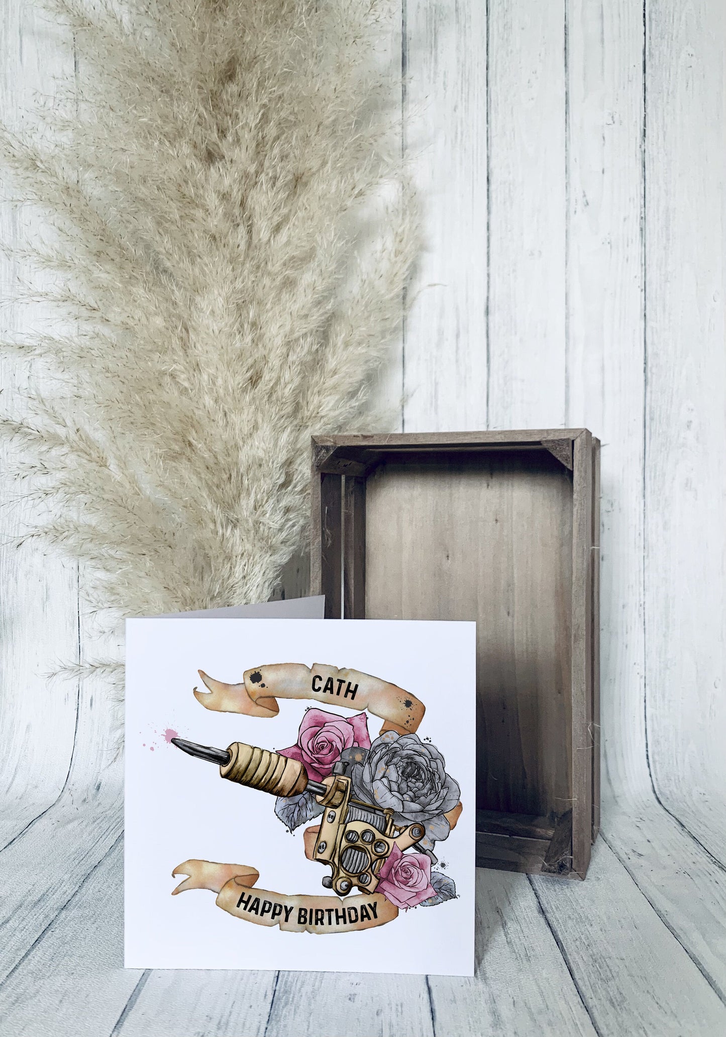 Birthday greeting card that can be personalised featuring a watercolour floral tattoo gun in pink