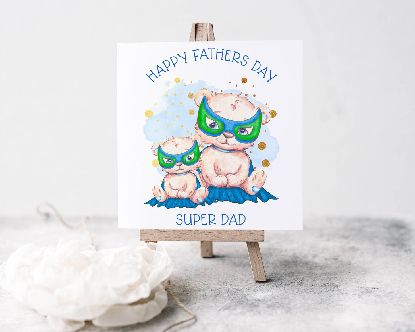Father's Day greeting card featuring a dad and baby bear in capes and masks.  The text reads 'Happy Father's Day Super Dad'