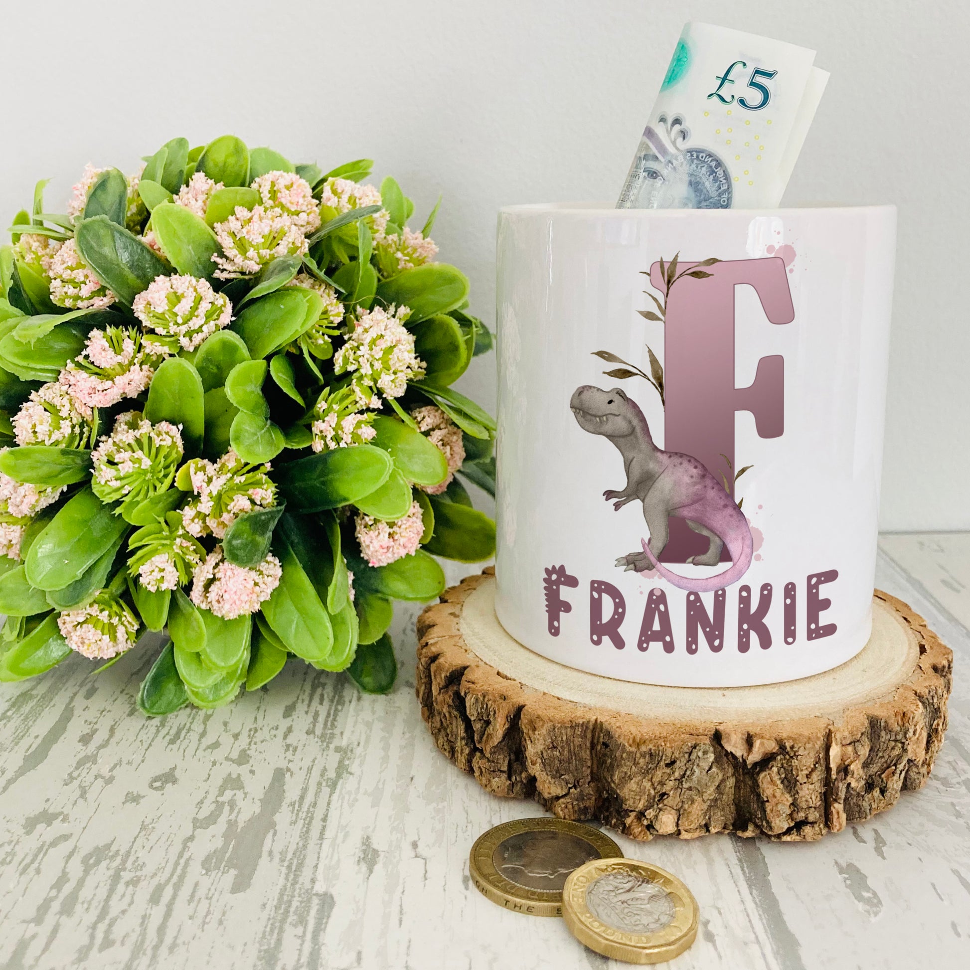 Personalised ceramic money box with a lilac dinosaur alphabet design