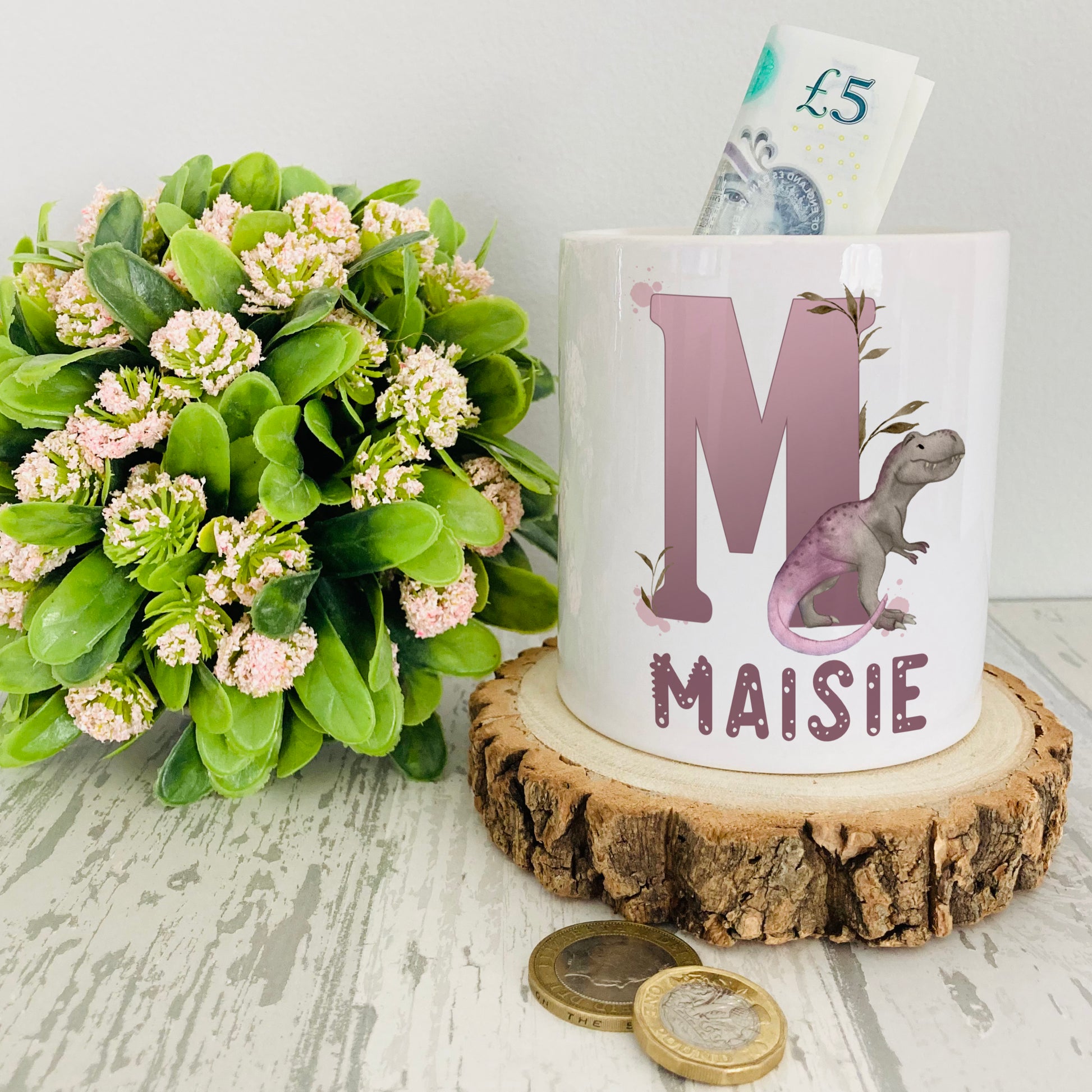 Personalised ceramic money box with a lilac dinosaur alphabet design