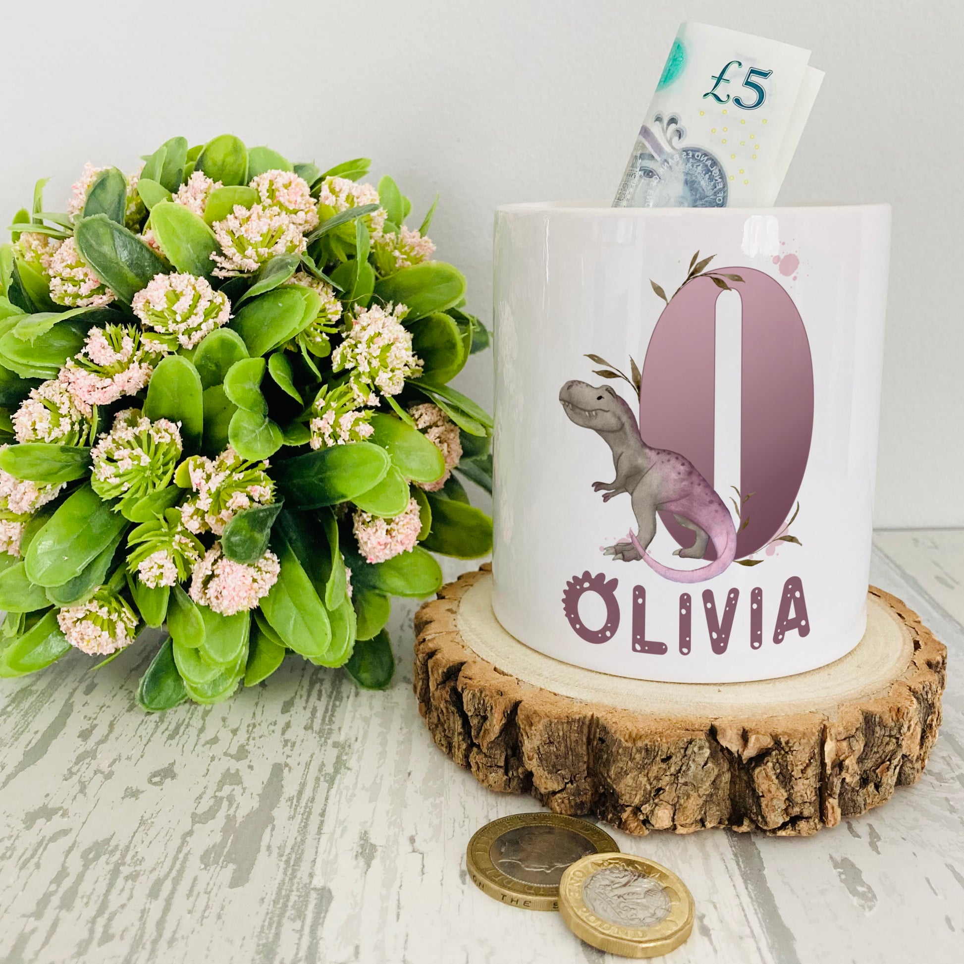 Personalised ceramic money box with a lilac dinosaur alphabet design