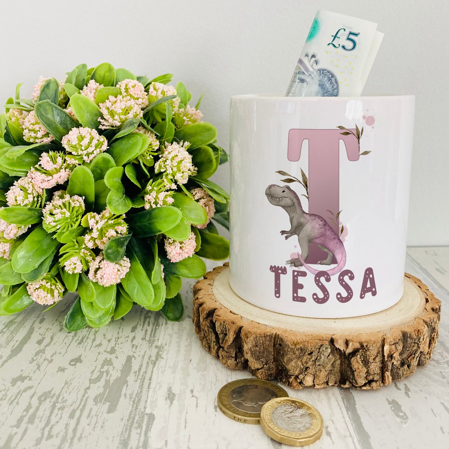 Personalised ceramic money box with a lilac dinosaur alphabet design